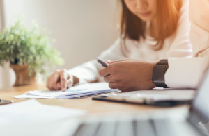 team working together. Modern workplace desks and computers, documents graphs showing the results of their successful.